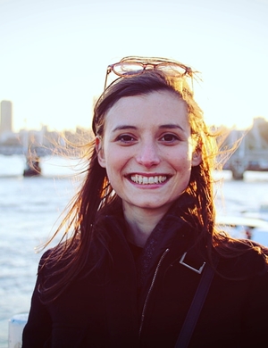 Caterina Domeneghini, smiling, standing in front of a river. 