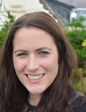 A photo of Rosie Wyles standing outside, smiling.