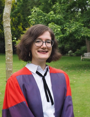 A photo of Alice Ahearn at graduation, smiling. 