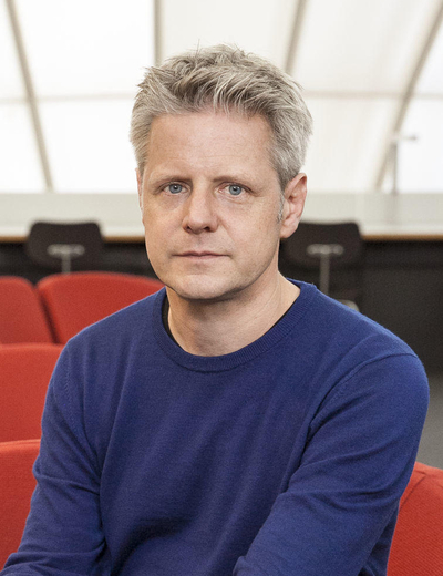 A photo of Matthias Warstat, sitting in an auditorium.