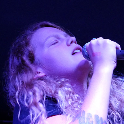 Close up of Kae Tempest performing, APGRD 2014