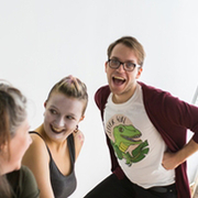 A photo of David Bullen, smiling, standing with actors. 