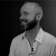 A black and white photo of Paul O'Mahony, smiling