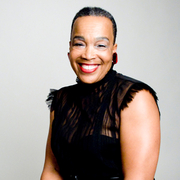 A photo of Rhodessa Jones, smiling.