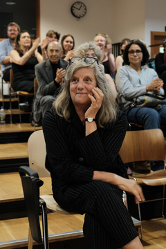 Professor Fiona Macintosh sat in a front row seat with a group of people behind her.