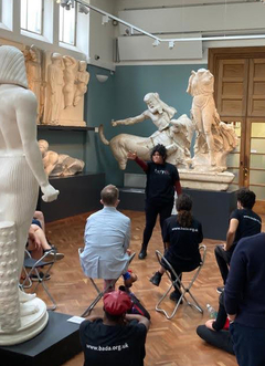 A group of students among ancient sculptures and casts at the Ashmolean museum