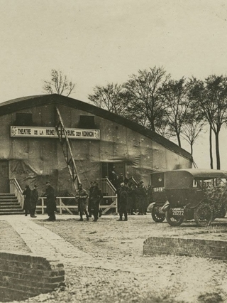 A sepia image of soldiers outside Theatre de la Reine. 